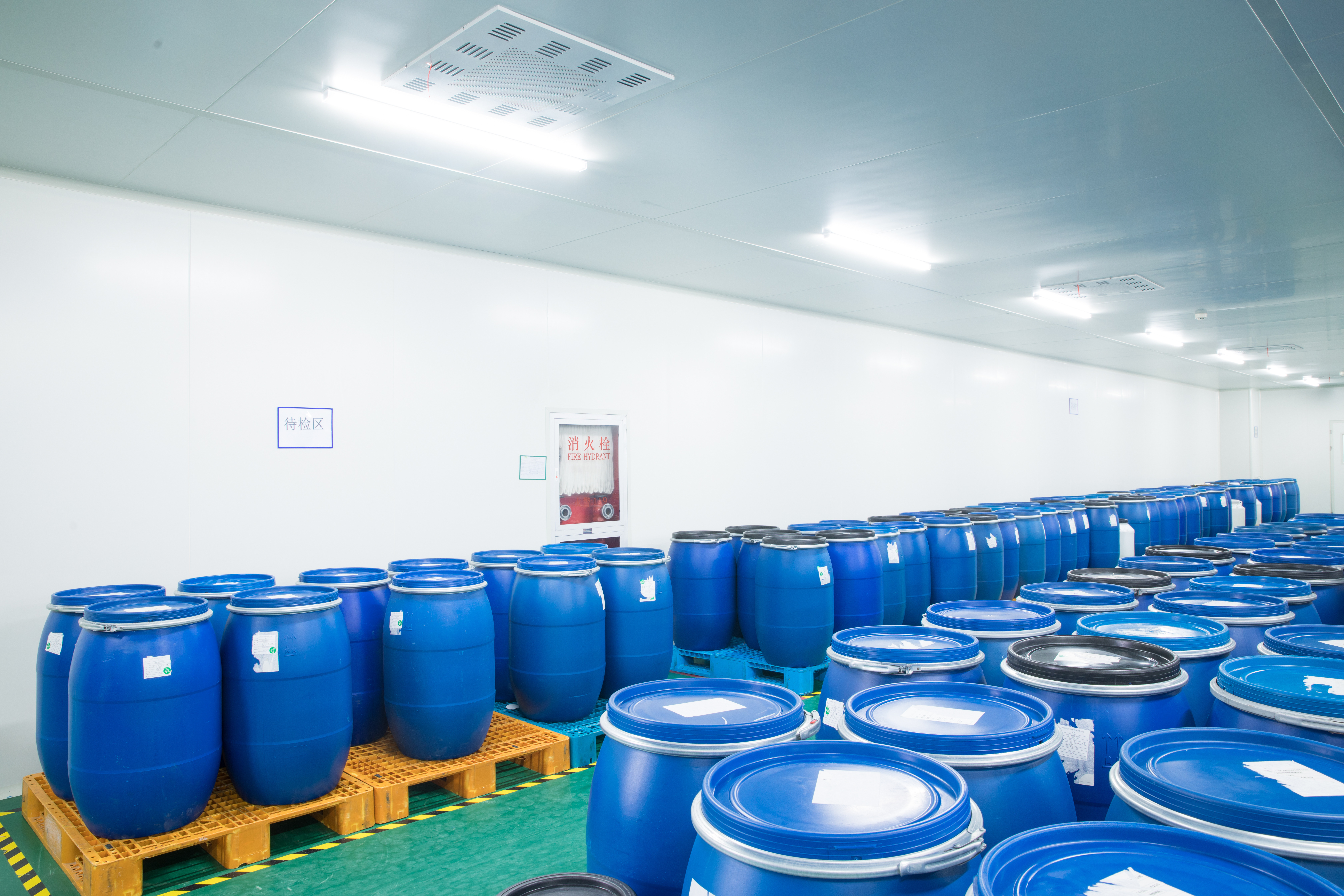 Warehouse area with rows of blue drums